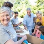 Happy volunteer family separating donations stuffs on a sunny da