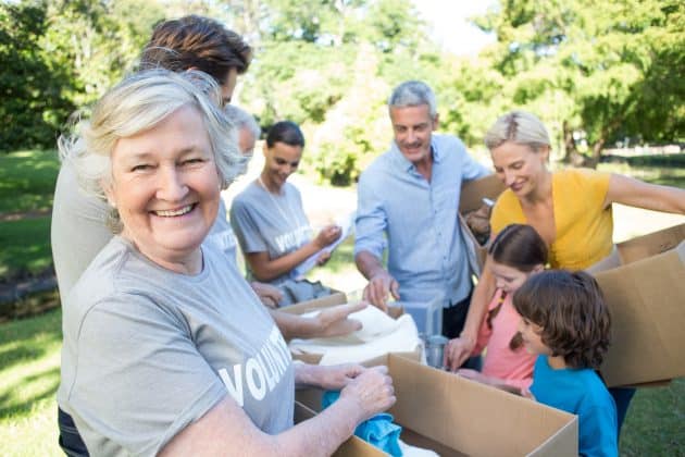 A senior citizen volunteers to help those in need by separating donations.