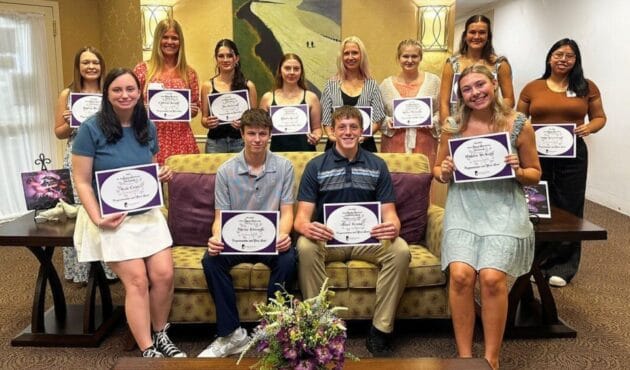 12 Silver Maples' staff members holding their scholarship awards