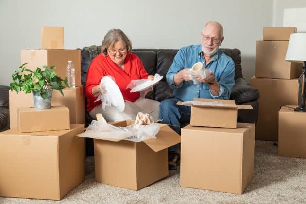 Senior couple packing up their belongings to relocate to a senior living community.