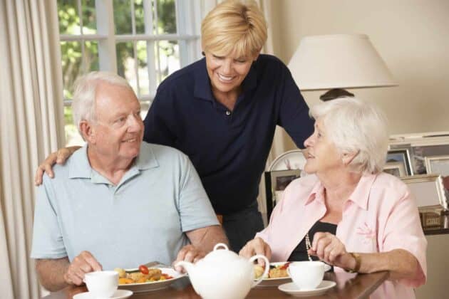 Senior couple sitting at a table enjoying a meal together