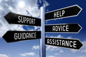 Metal signpost with five arrows - help, support, advice, guidance