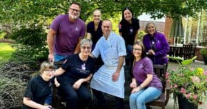 A group of Silver Maples friendly staff gathered outdoors in our patio area.