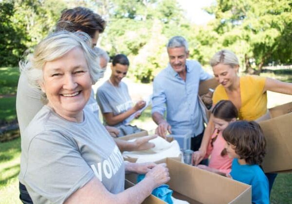 Happy volunteer family separating donations stuffs on a sunny da