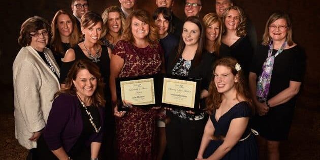 Julie Deppner and Samantha surrounded by staff, board members and family.