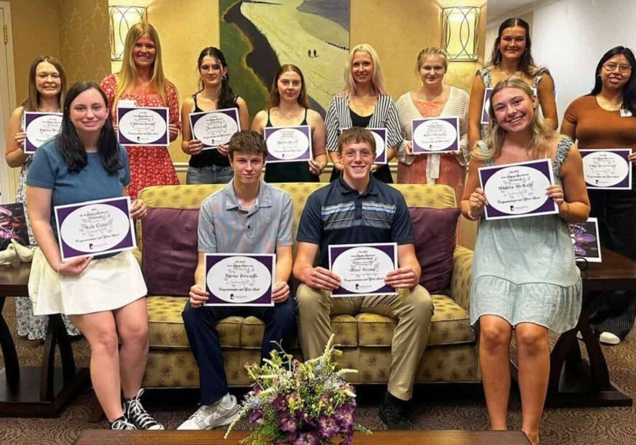 12 Silver Maples' staff members holding their scholarship awards