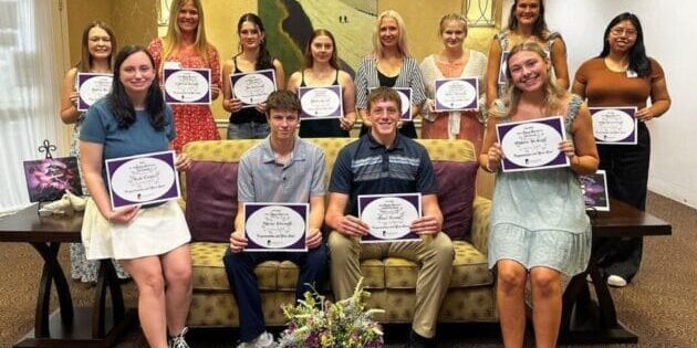 12 Silver Maples' staff members holding their scholarship awards