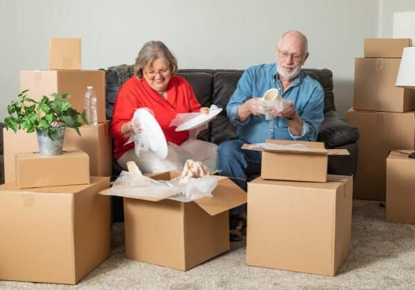 Senior couple packing up their belongings to relocate to a senior living community.