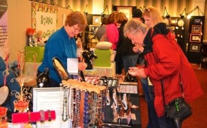 Shoppers browse artisan Becky House’s jewelry. House is one of 20 artisans exhibiting at the 6th annual Harvest Art Market in Chelsea on Saturday, Oct. 12.)