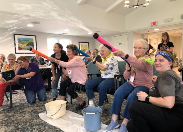 When the temps rise, we find cool ways to beat the heat! Our luau-themed Super Soaker challenge was a splash-tastic success. Residents took aim at our brave and playful RCAs and volunteers, who were ready to get soaked for some summertime fun. 🏝️💦

Some were hesitant at first (it feels so wrong to squirt the people who care for you!), but they quickly got the hang of it and let those Super Soakers fly. 😆

We love creating moments like these that bring joy, laughter, and just the right amount of mischief to the day. #SummerFun  #LuauVibes #SoakedWithLove #hereinthemeadows
